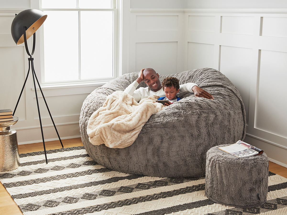 Dad relaxing with son in Lovesac's BigOne Sac.